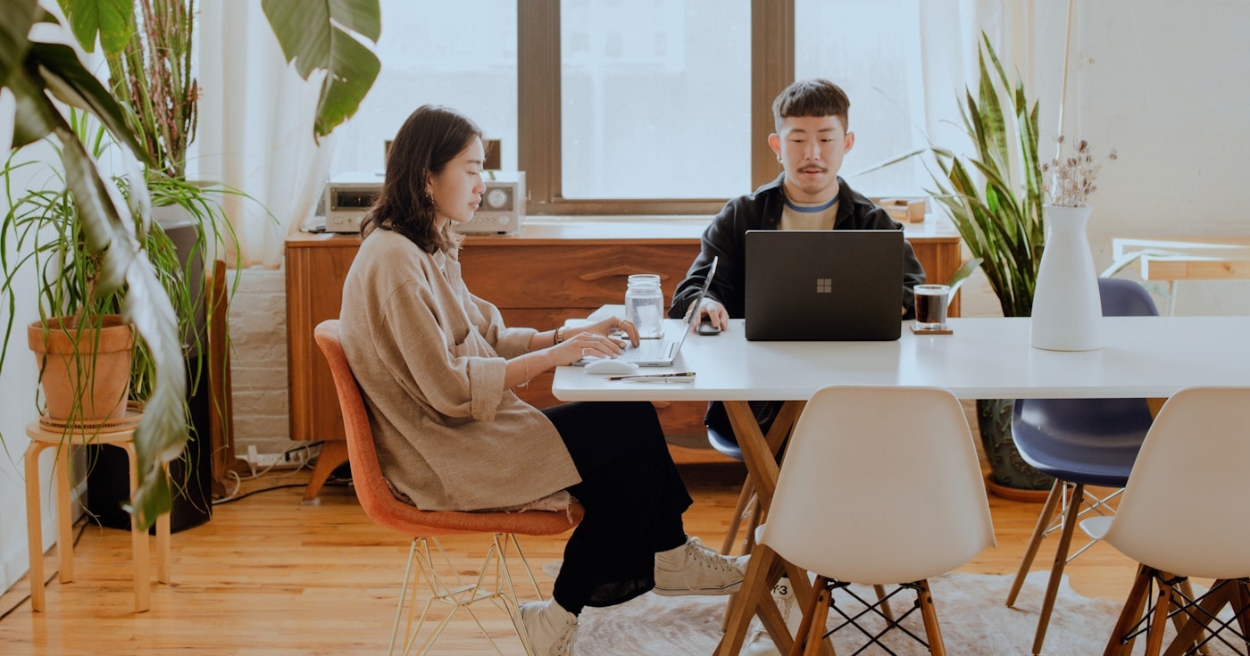 Two people collaborating in a hybrid work setting