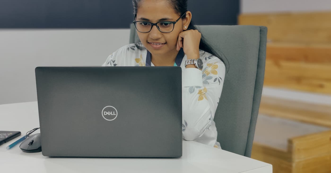 Office worker sitting at laptop, disengaged from work