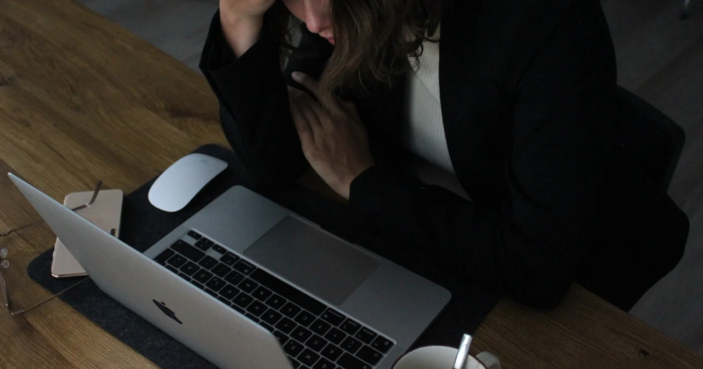 Person at desk showing signs of workplace burnout and stress