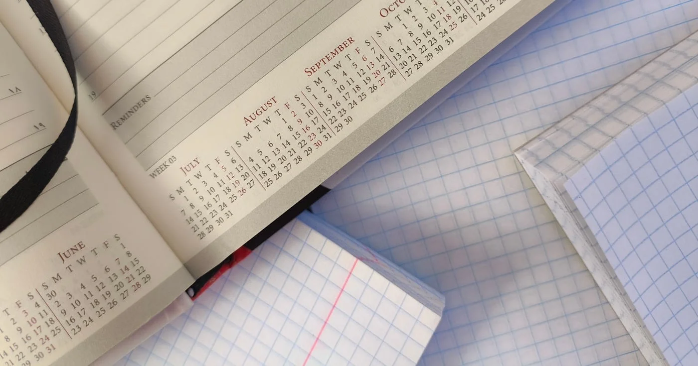 Open planner showing calendar months, the container Parkinson's Law fills